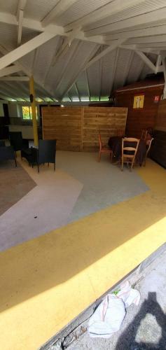 an empty room with chairs and tables in a building at les gîtes de la belle fleur laurier rose in Le Gosier