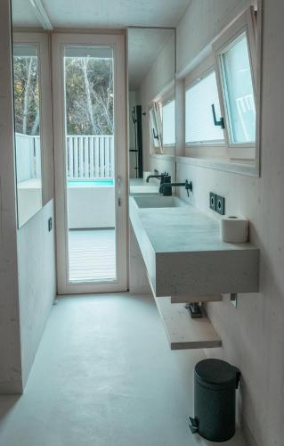 a bathroom with a large sink and two mirrors at Villa Gioia Beach Front in Drage