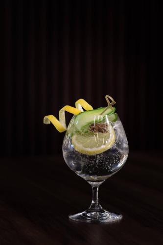 a glass vase with a flower in it at AC Hotel by Marriott Bratislava Old Town in Bratislava