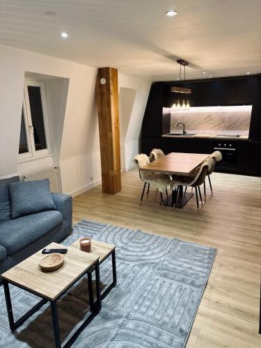 un salon avec un canapé bleu et une table dans l'établissement Le Nid de la Cathédrale, à Colmar