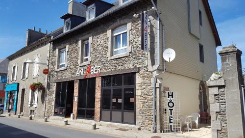 a stone building on the side of a street at AN ABER Hôtel Café in Lannilis