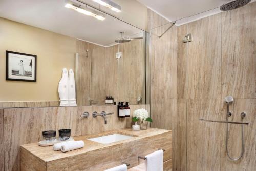 a bathroom with a sink and a shower at Tivoli Palazzo Gaddi Firenze Hotel in Florence