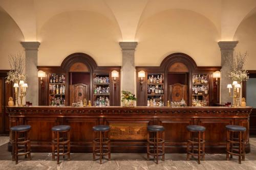 a bar in a building with stools at Tivoli Palazzo Gaddi Firenze Hotel in Florence