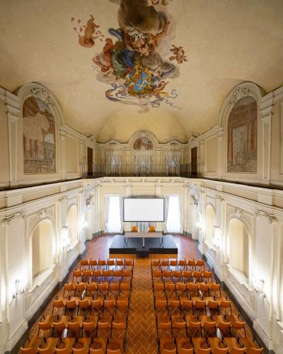 an empty room with a stage and chairs in it at Tivoli Palazzo Gaddi Firenze Hotel in Florence