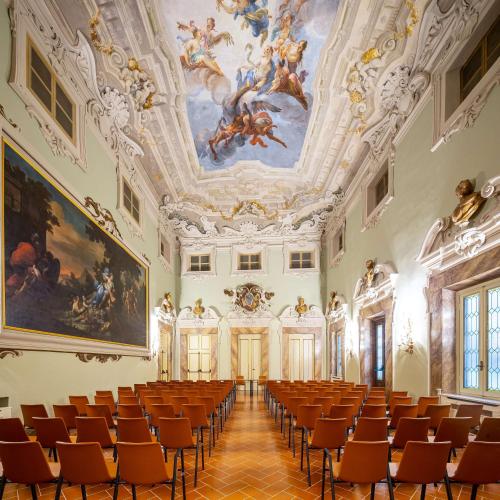an empty room with chairs and paintings on the ceilings at Tivoli Palazzo Gaddi Firenze Hotel in Florence