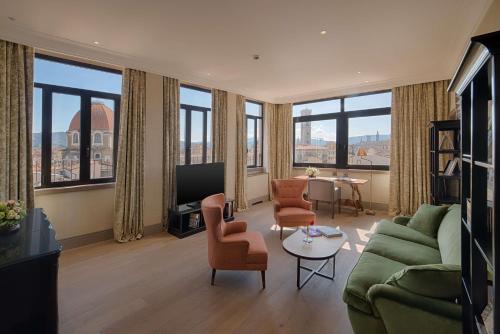 a living room with a green couch and chairs at Tivoli Palazzo Gaddi Firenze Hotel in Florence