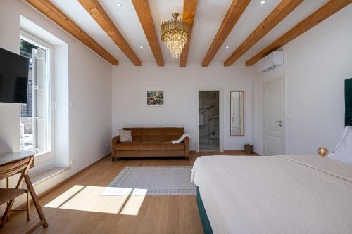 a bedroom with a bed and a couch in a room at Villa Ljubica in Suđurađ
