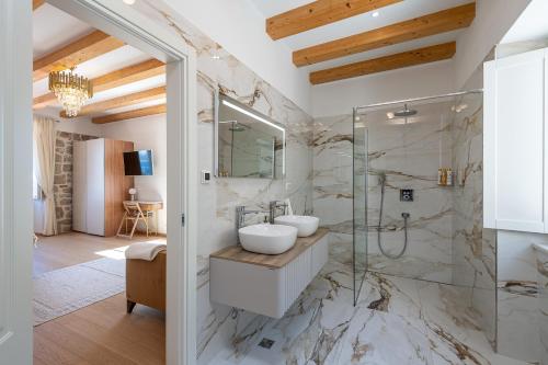 a bathroom with a sink and a shower at Villa Ljubica in Suđurađ