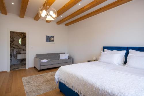 a bedroom with a large bed and a couch at Villa Ljubica in Suđurađ