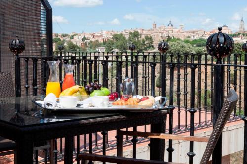 a tray of fruit on a table on a balcony at AC Hotel Ciudad de Toledo by Marriott in Toledo