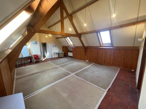 an attic room with a tennis court in it at La Ferme Saint Pierre de Glabais in Genappe