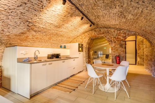 a kitchen with a table and chairs and a brick wall at Luxurious canal apartment in Utrecht A Location in Utrecht