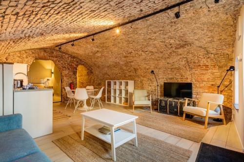 a living room with a brick wall at Luxurious canal apartment in Utrecht A Location in Utrecht