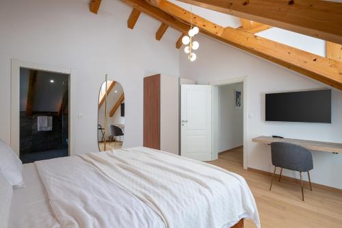 a bedroom with a large bed and a television at Villa Ljubica in Suđurađ
