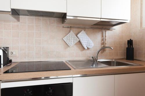 a kitchen with a sink and a counter top at Youhosty - Paul Valery Bis in Milan