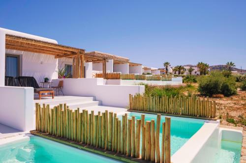 a house with a swimming pool and a fence at Aegean Hospitality in Mýkonos City