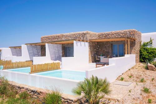 a villa with a swimming pool in the desert at Aegean Hospitality in Mýkonos City