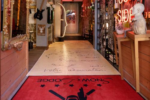 a store hallway with a red rug on the floor at Snow Lodge Hotel Courchevel 1850 in Courchevel