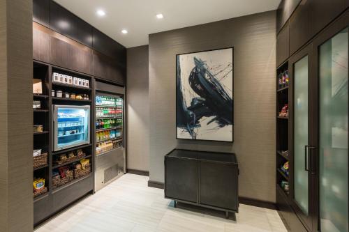 a walk in pantry with a gun painting on the wall at AC Hotel by Marriott Worcester in Worcester