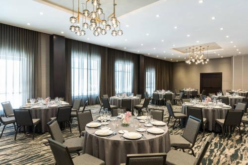 a conference room with tables and chairs and a podium at AC Hotel by Marriott Worcester in Worcester