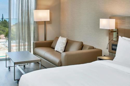 a hotel room with a bed and a couch at AC Hotel Miami Wynwood in Miami