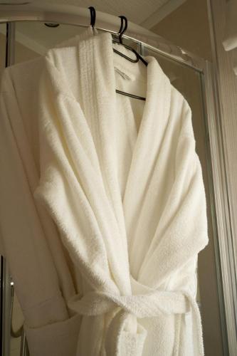 a white towel hanging on a rack in a bathroom at Hollicarrs - Bumblebee Lodge in York