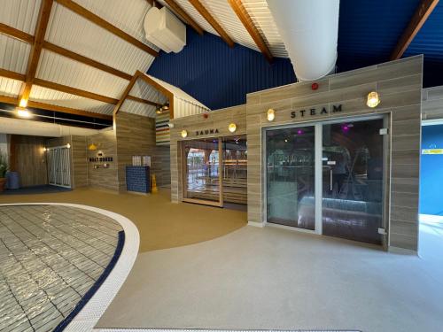 a train station lobby with a train on the wall at Spring Lodge in South Cerney