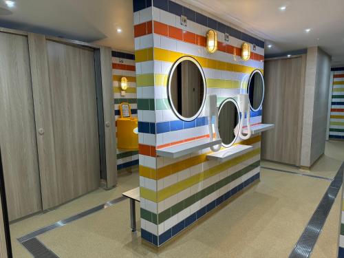 a colorful bathroom with two washing machines on a wall at Spring Lodge in South Cerney