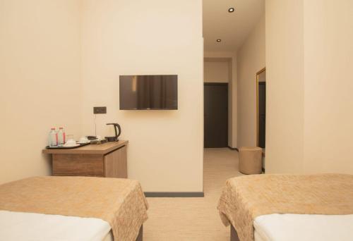 Postel nebo postele na pokoji v ubytování Twelve Inn Hotel