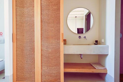 a bathroom with a sink and a mirror at Aegean Hospitality in Mýkonos City