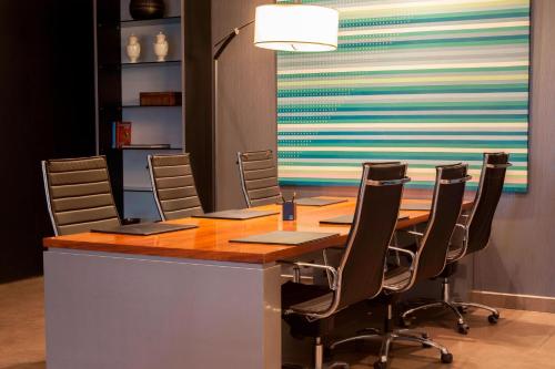 a conference room with a long table and chairs at AC Hotel by Marriott Madrid Airport in Coslada