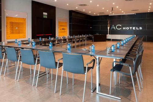 a conference room with a long table and chairs at AC Hotel by Marriott Madrid Airport in Coslada