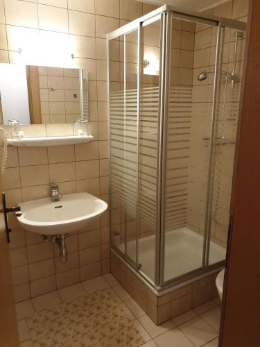 a bathroom with a shower and a sink at Berghotel Türlwand in Ramsau am Dachstein