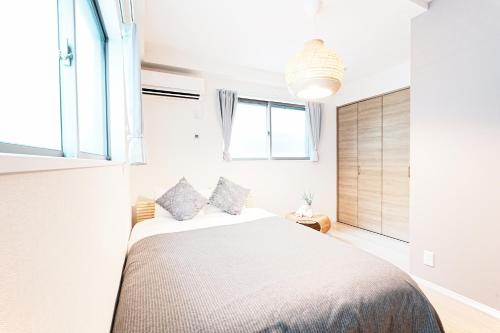 a bedroom with a bed and a window at Degere in Tokyo
