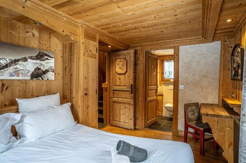 a bedroom with a bed in a wooden room at Chalet l'écureuil in Méribel