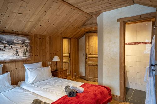 a bedroom with a bed in a wooden room at Chalet l'écureuil in Méribel