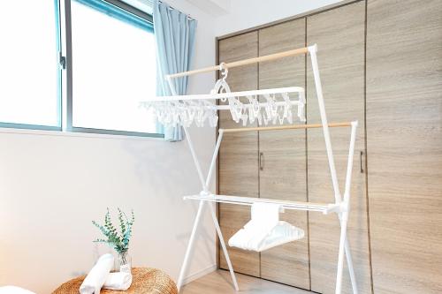 a white shelf in a room with a window at Degere in Tokyo