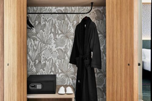 a robe hanging on a door in a bedroom at Renaissance Phoenix Glendale Hotel & Conference Center in Glendale