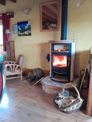 a fireplace in a living room with a stove at Au restalèz in Trémargat