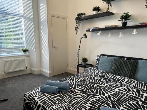 a zebra print bed in a room with a window at Bright and spacious apartment near Glasgow in Dalmuir