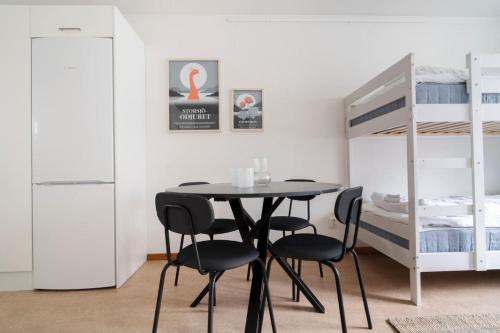 a dining room with a table and chairs and a bunk bed at Cozy Studio for 4 Your Home Away from Home in Lugnvik