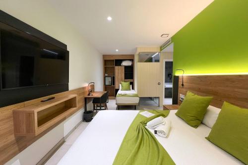 a hotel room with a large television and a bed at Hotel MG Poniente in Las Palmas de Gran Canaria