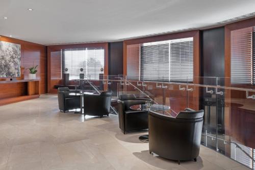 a dining room with black chairs and a table at AC Hotel Gran Canaria by Marriott in Las Palmas de Gran Canaria