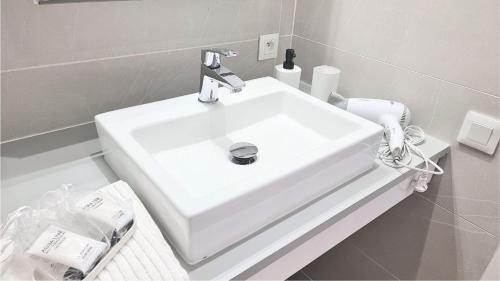 a bathroom with a white sink and a toilet at COCOON Neuf - Climatisé - Centre ville in Cogolin