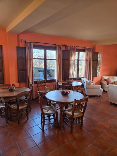 a living room with tables and chairs and a couch at Hotel el Castellar in Moscardón