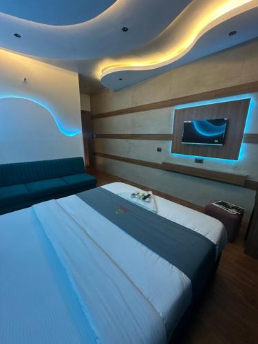 a bedroom with a large bed and a tv at Hotel victoria prime in Surat