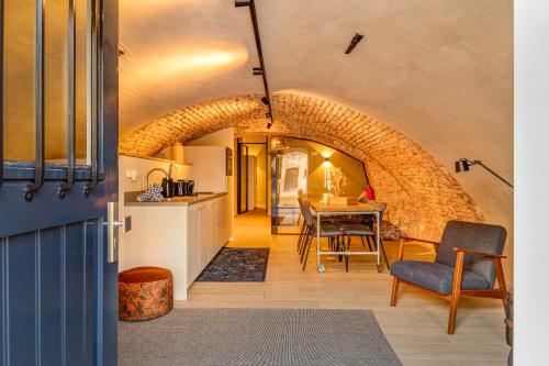 a kitchen and dining room with a brick wall at 4P Unique canal apartment A Location in Utrecht in Utrecht