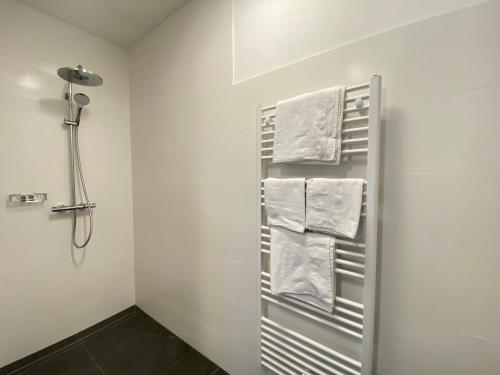 a bathroom with a towel rack with towels at Ferienwohnung EPIKUR in Payerbach