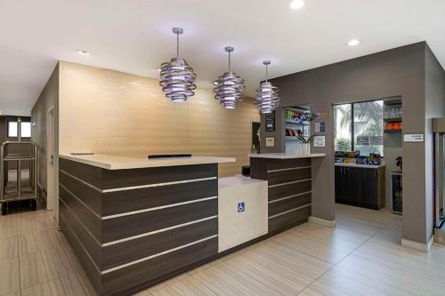 a kitchen with a counter and two lights at Best Western Plus Gardena-Los Angeles Inn & Suites in Gardena