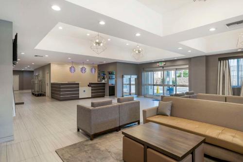 a living room with a couch and a table at Best Western Plus Gardena-Los Angeles Inn & Suites in Gardena